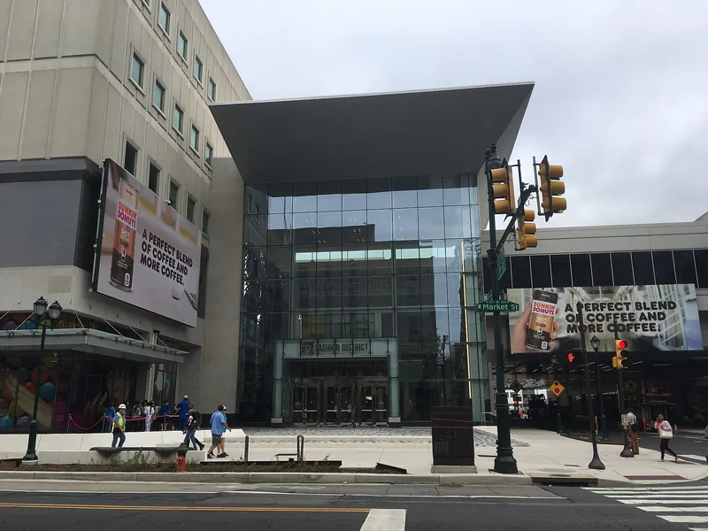 Glass entrance of the Fashion District Philadelphia mall on Market Street